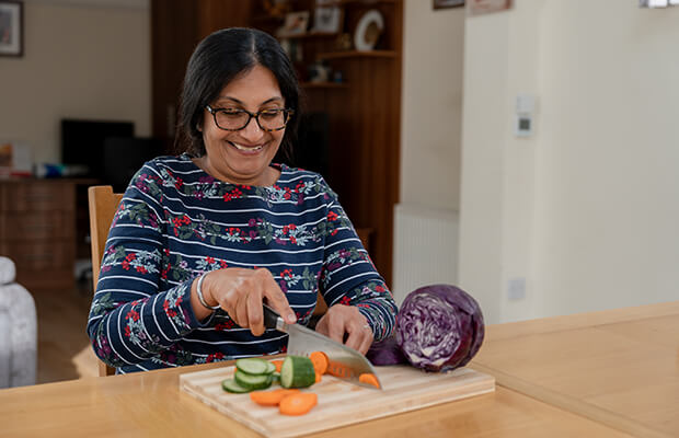 Hina Shah chops vegetables with a knife