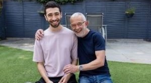Martin Unerman and his son Matthew sit together on the garden wall.