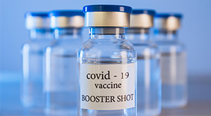 Close up of vials with a label saying "Covid-19 vaccine".