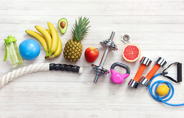 Weights, resistance bands, fruit and gym equipment from above.