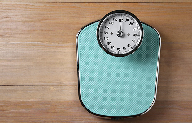 Weighing scales on a wooden floor from above.