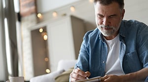 A person fills out a diary while sitting at the desk