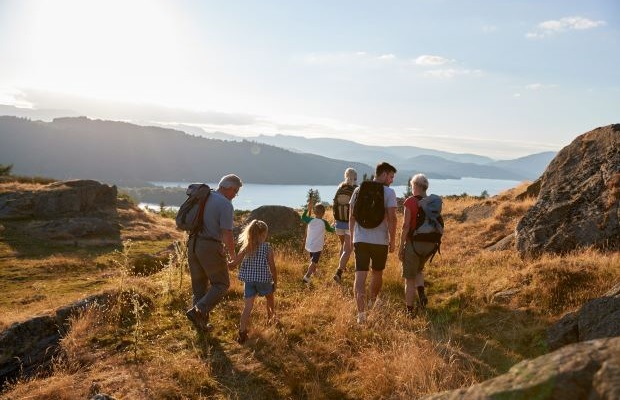 A family walking by the coast on a sunny day.