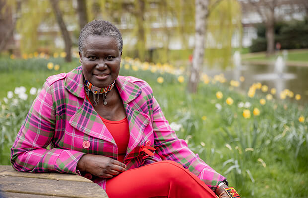 Alice Odeke sits in a garden