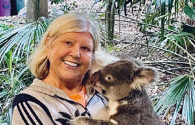 Sandra holds a koala in a sanctuary in Australia