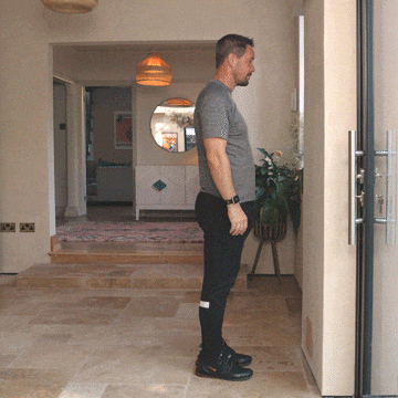Andrew Scard demonstrates a standing calf stretch.