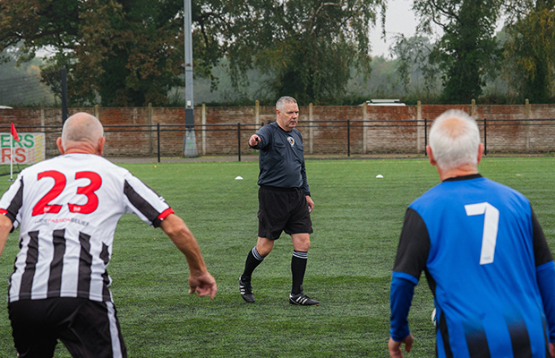 Kevin refeering a walking football match.