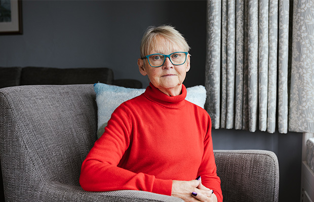 Helen Wilberforce sitting on a chair at home.