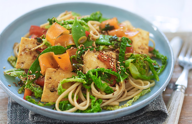 A plate of a vegetable stir-fry on a table.