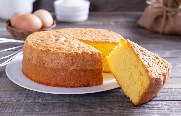 A plain sponge cake on a table.