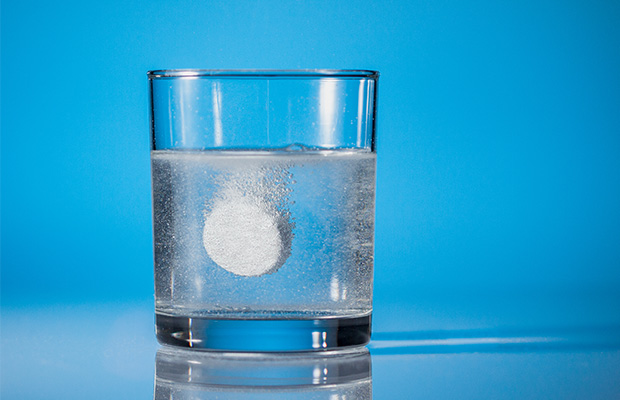 A tablet dissolving in a glass of water.