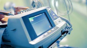 A heart rate monitor in a hospital with a flat line.