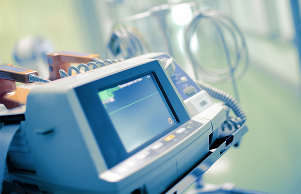 A heart rate monitor in a hospital with a flat line.