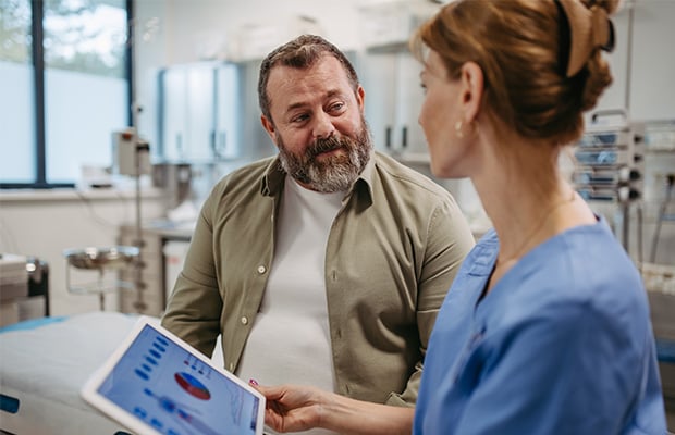 A man speaks to a healthcare provider about test results.
