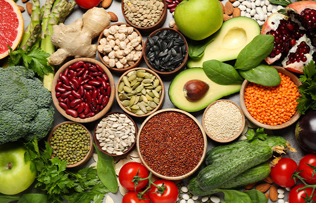 Variety of foods including avocado, beans, broccoli, tomatoes and nuts