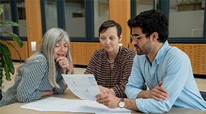 Professor Barbara Casadei, Professor Louise Bowman and Guilherme Amorim look at ECG results.