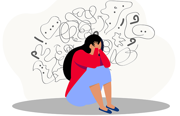 Illustration of a person crouched over on the floor with their head in their hands with scribblings around their head suggesting negative mental thoughts. 
