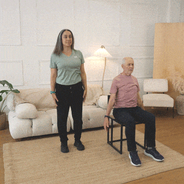 Hara and Peter lifting their arms up and stretching the side of the body.