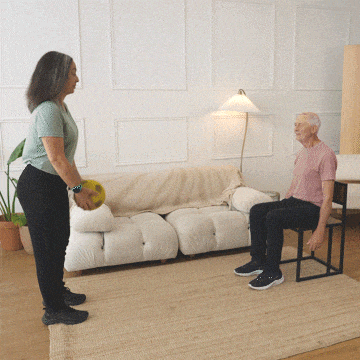 Hara and Peter throwing a ball back and forth.