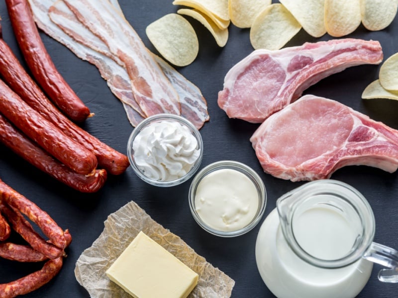 Foods high in saturated fat, including bacon, butter, crisps and cream.