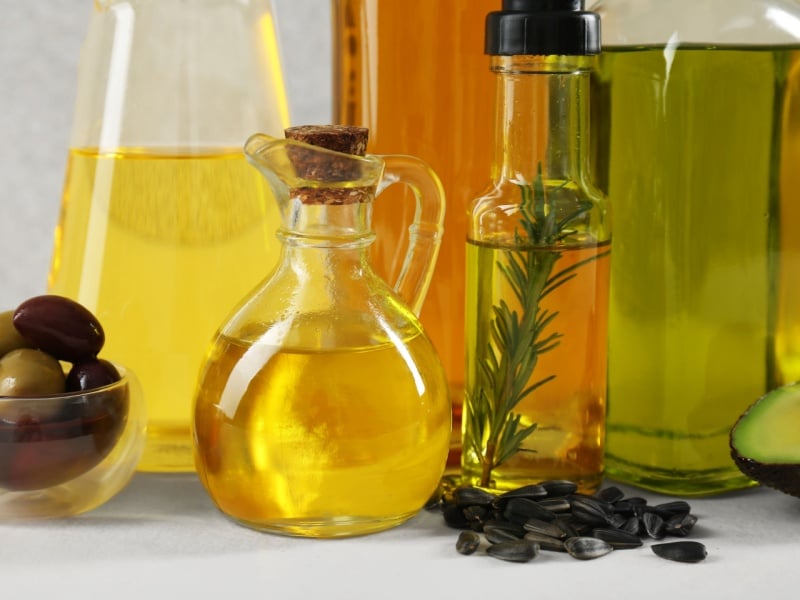 Different types of vegetable oils in glass bottles.