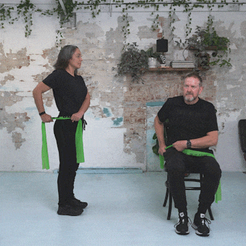 Hara and Peter performing a standing and seated tricep extension.