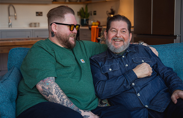 James Hall on a sofa with his dad Chris,