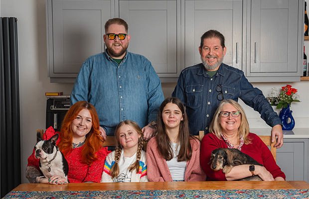 James Hall with his wife, parents and 2 daughters in his home.