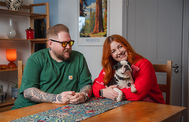 James Hall sat at a table with his wife Laura holding their dog.
