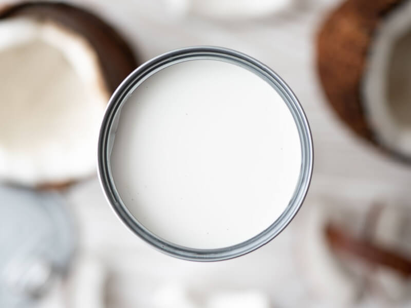 An aerial shot of an open can of coconut milk.