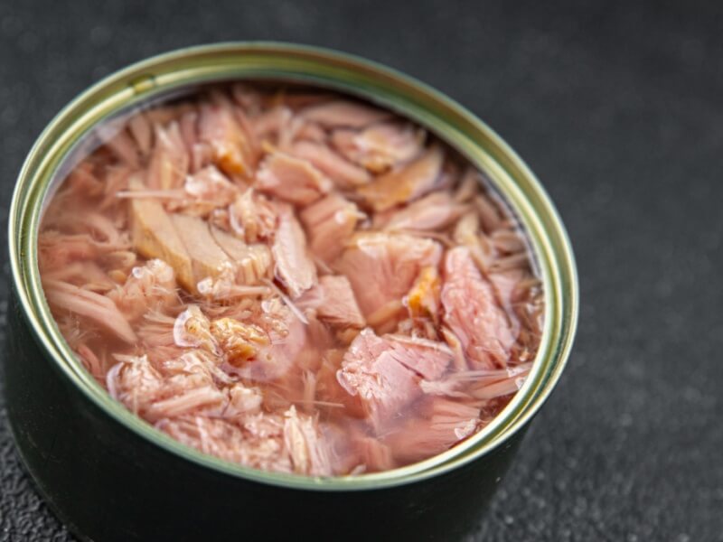 An open tin of canned tuna.