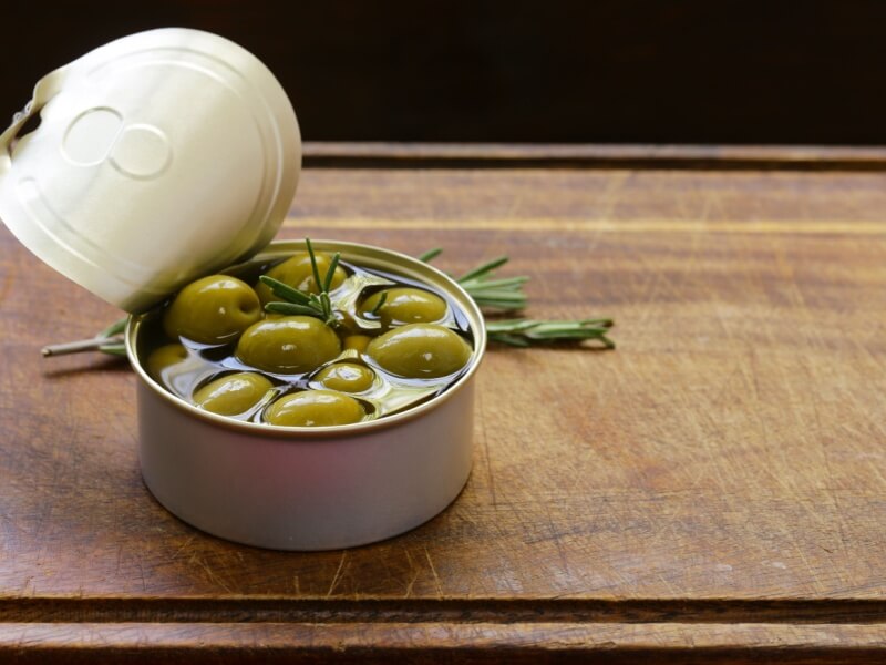 An open tin of olives.