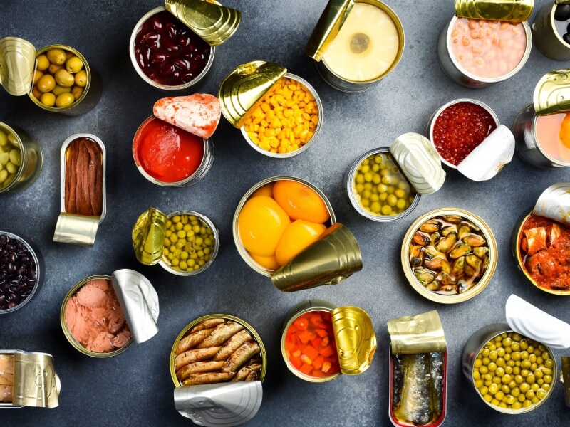 An aerial shot of lots of tins with a variety of foods in them.