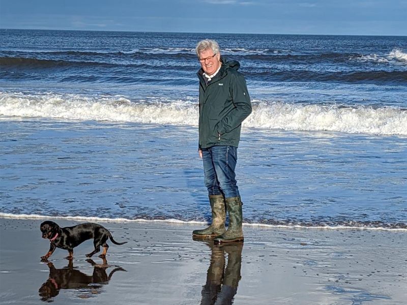Ray Jenkins walking his dog on the beach.