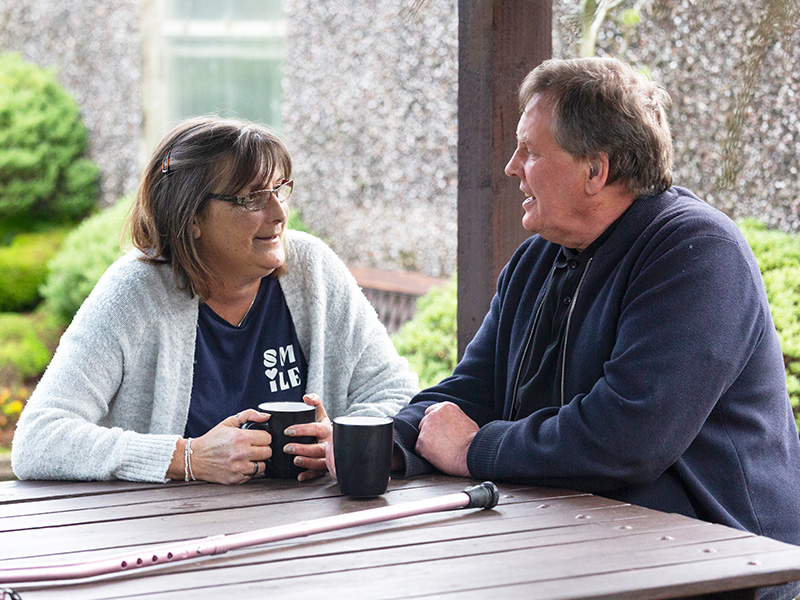 Barbara Colclough, who has lupus, sitting outside with her husband Craig.