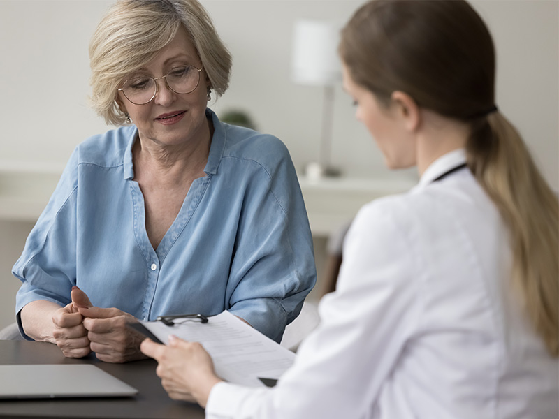 A woman speaking with a healthcare professional.