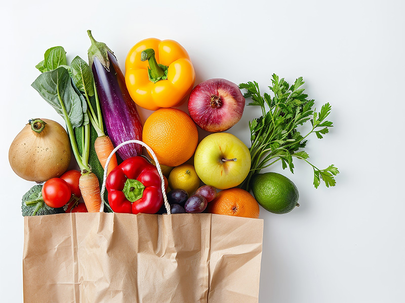 Fresh fruit and veg in brown paper bag