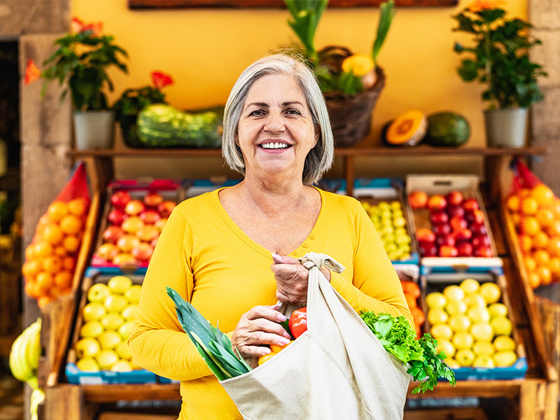 Mature woman shopping for fruit and vegetables