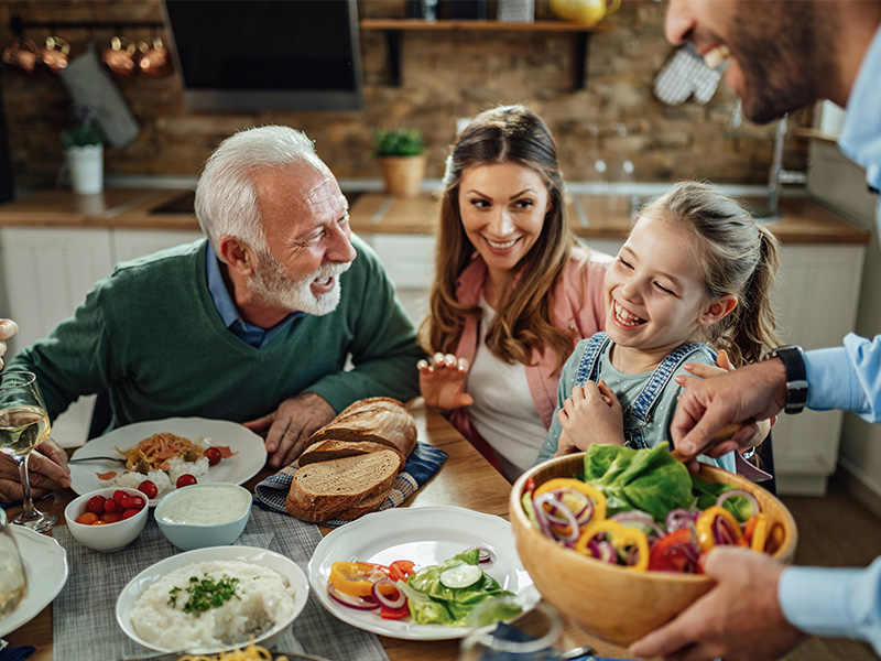 A family serving and eating dinner at home.