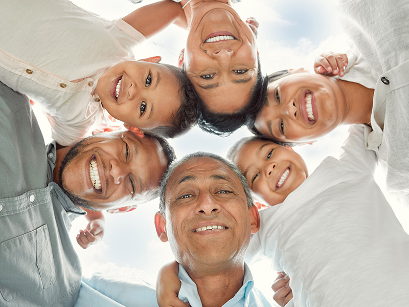A family in a circle looking down from above.