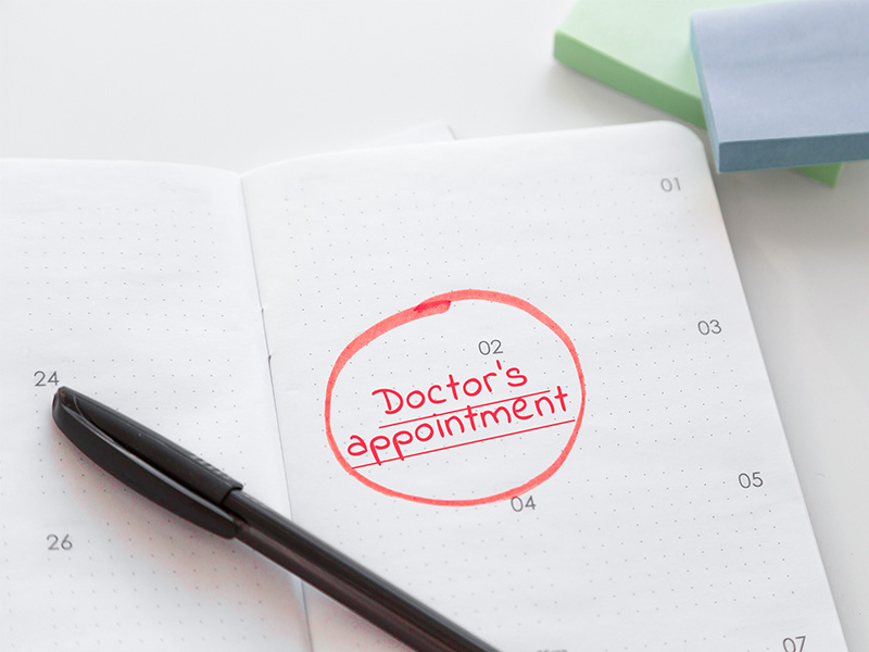 An open diary with "Doctor's appointment" written inside.