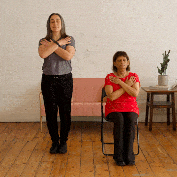 Hara and Corinne standing with their eyes closed.