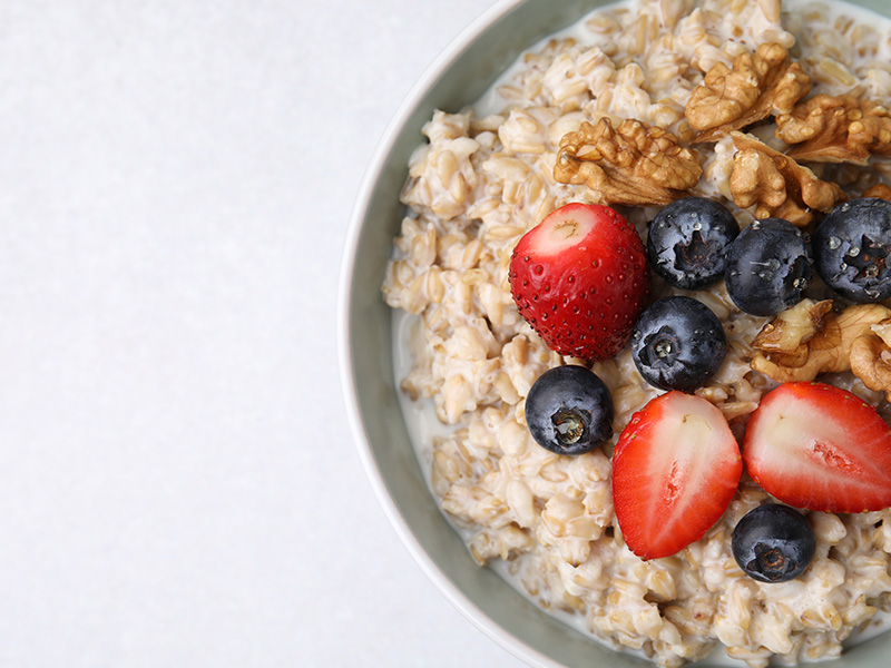 Bowl of healthy porridge with blueberries and strawberries