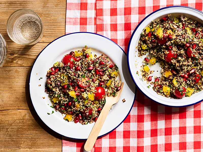 Two plates of quinoa salad on a table.