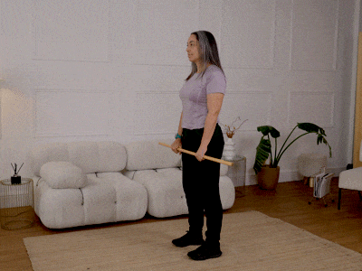 Hara performing a deadlift with a broom handle.