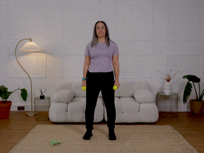 Hara performing a squat with a bicep curl.