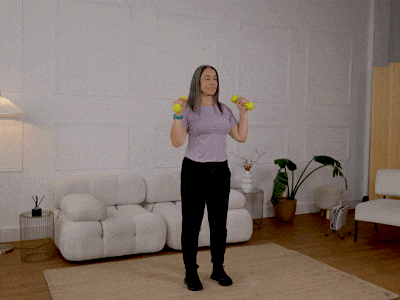 Hara performing a standing shoulder press with weights.