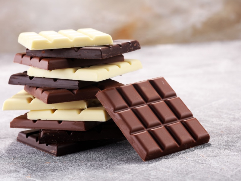 A pile of dark, milk and white chocolate bars.