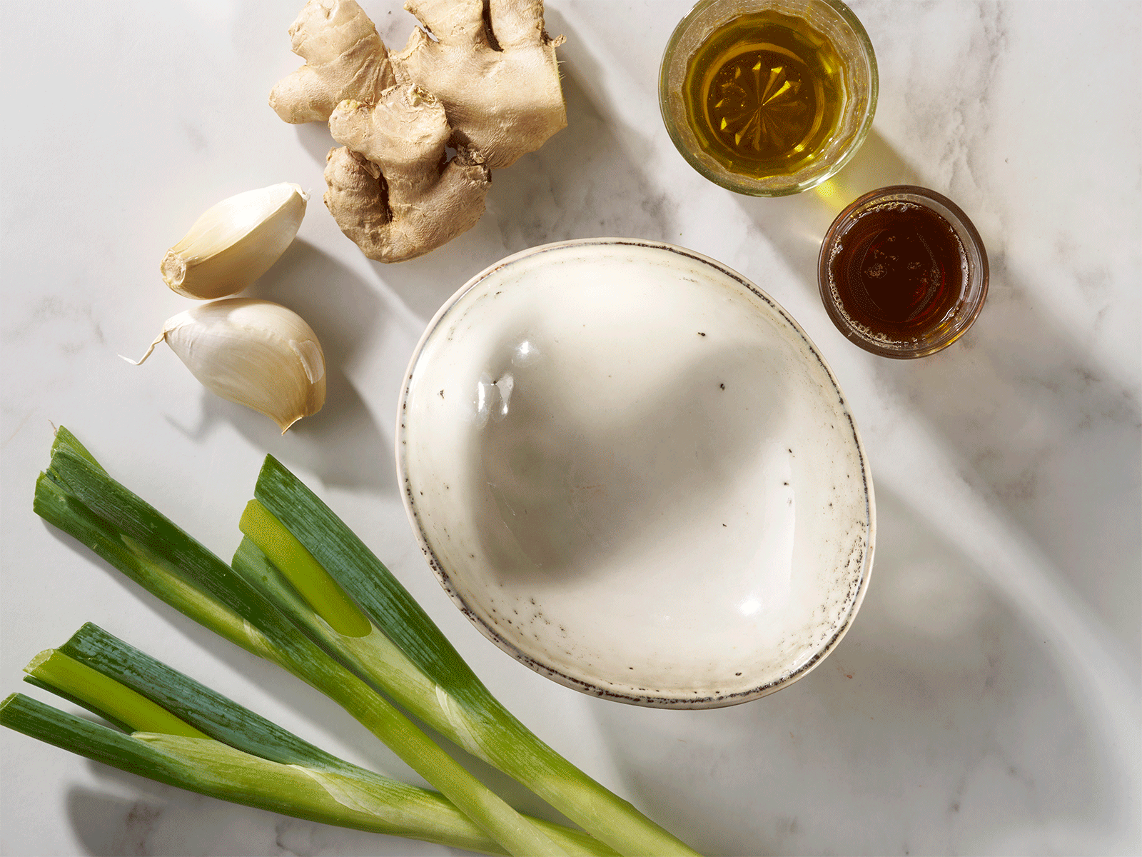 Fresh ginger, garlic and spring onion stir fry sauce being made step by step.