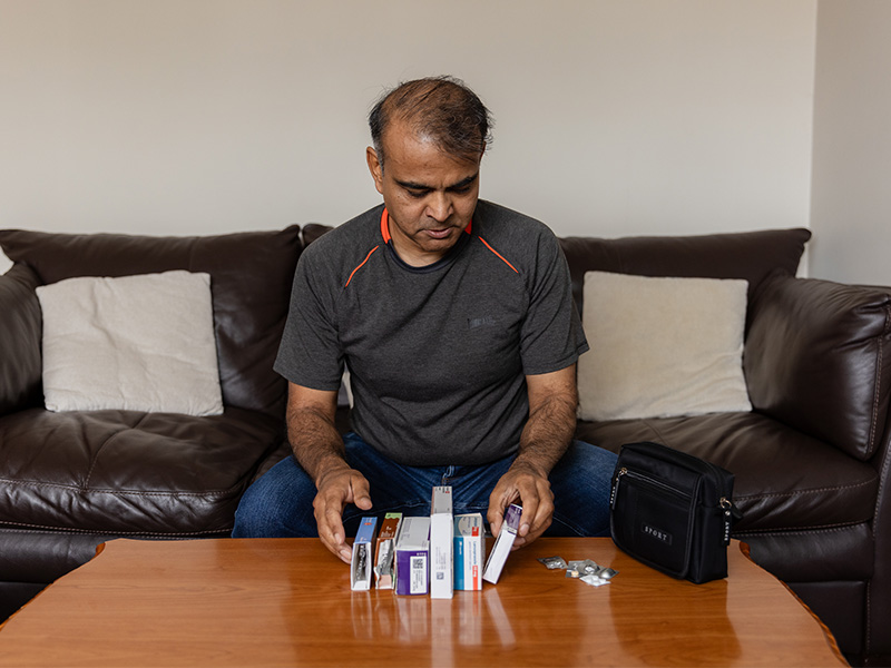 Amir with the different types of medicines he takes.